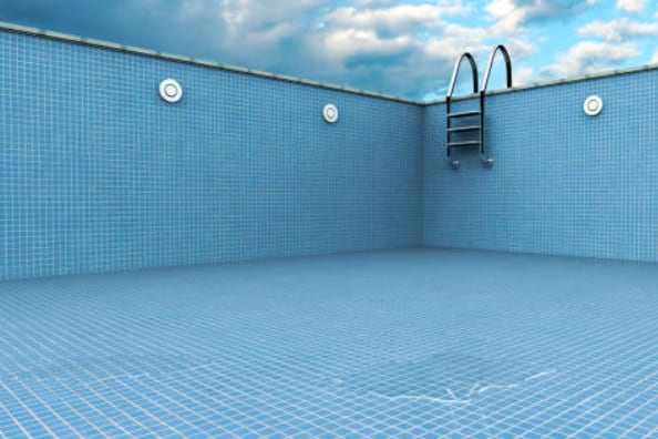 Empty swimming pool illustrating water loss from a pool leak